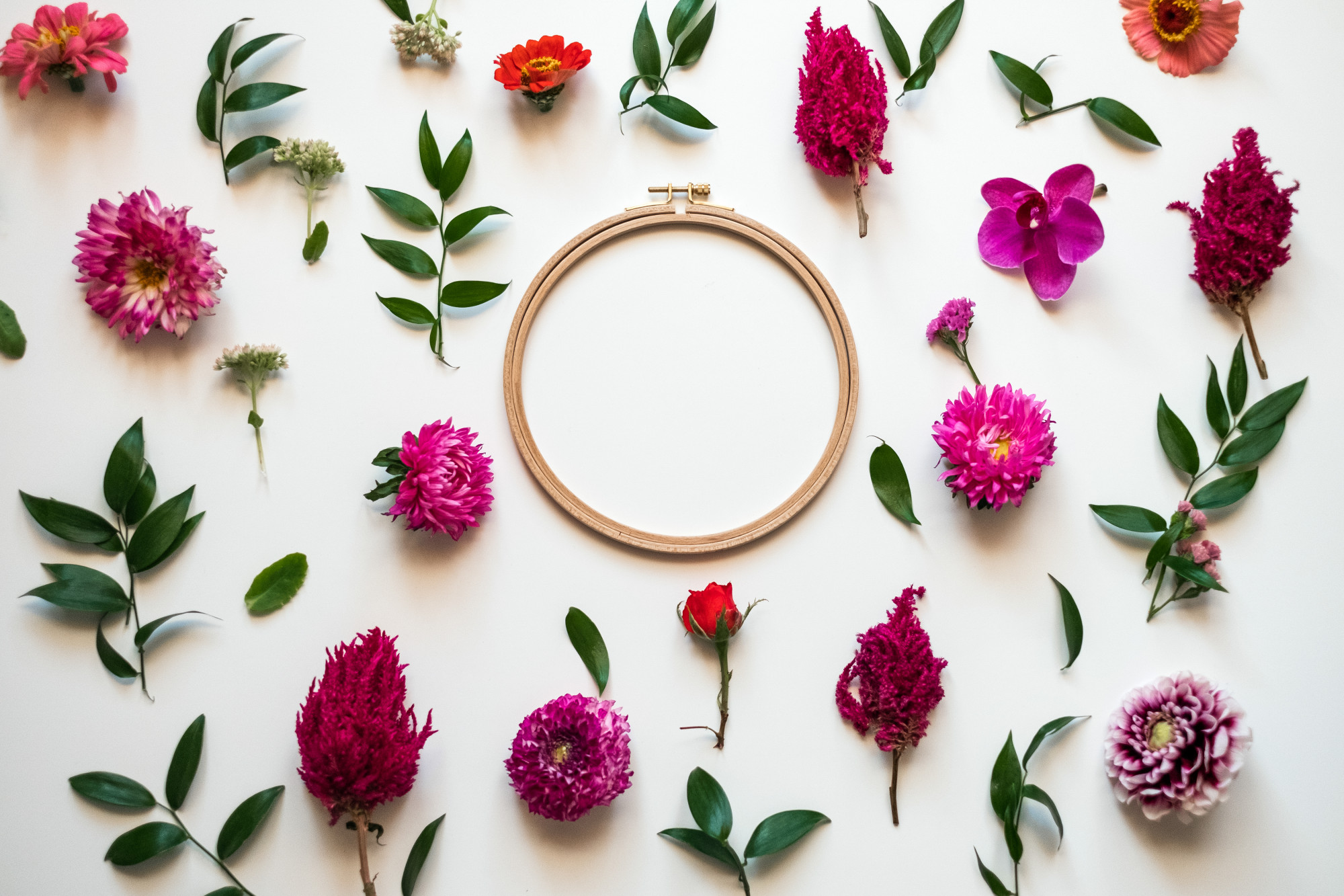 Close-up of hand embroidery hoop with floral stitches